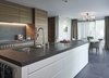 Modern home with Kitchen, Stone Counter, Wood Cabinet, Wall Lighting, Ceiling Lighting, Refrigerator, Wall Oven, Cooktops, and Undermount Sink. Kitchen dining grand parents Photo 17 of Rock'n Roll