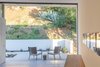 Modern home with Outdoor, Slope, Hardscapes, Small Patio, Porch, Deck, and Garden. Patio from Master Suite Photo 12 of Oaks Parkhouse