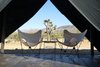 Modern home with Living Room, Chair, Coffee Tables, and Dark Hardwood Floor. Folding canvas butterfly chairs and table Photo 3 of Joshua Tree Case Study Cabin