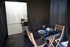 Dining area and kitchen / bathroom shown with privacy curtain, hiding the composting toilet Photo 10 of Joshua Tree Case Study Cabin modern home
