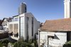 Modern home with House Building Type, Tile Roof Material, Stucco Siding Material, Windows, Metal, and Wood. The Charm Townhouse - Back and Side facades - in contrast with the street facade Photo 2 of The Charm Townhouse