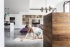 Modern home with Living Room, Chair, Ottomans, Coffee Tables, Pendant Lighting, Concrete Floor, Media Cabinet, Bookcase, and Shelves. The Charm Townhouse - Meirav Galan - Architect & fringes' straightener Photo 4 of The Charm Townhouse