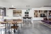 Modern home with Kitchen, Marble Counter, White Cabinet, Brick Backsplashe, Pendant Lighting, Track Lighting, Concrete Floor, Ceiling Lighting, Wall Oven, Cooktops, and Undermount Sink. The Charm Townhouse - A combination of clean, neutral modern furniture mixed with interesting textures and warmth from rugs, and accessories Photo 6 of The Charm Townhouse