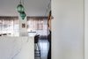 Modern home with Kitchen, Marble Counter, White Cabinet, Concrete Floor, Pendant Lighting, Track Lighting, and Ceiling Lighting. The Charm Townhouse - Minimalist finishes and details combined with art, accessories and lighting
chosen to bring interest and special accents to the space Photo 7 of The Charm Townhouse