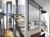 Modern home with Staircase, Metal Tread, Wood Tread, and Metal Railing. The Charm Townhouse - Airy vertical circulation - hovering stairs surrounded by full height windows and detached walls Photo 9 of The Charm Townhouse
