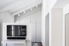 Modern home with Dresser, Ceiling Lighting, Medium Hardwood Floor, Storage Room, Cabinet Storage Type, and Closet Storage Type. The Charm Townhouse - Master bedroom closet room Photo 13 of The Charm Townhouse