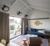 Modern home with Bed, Wall Lighting, Medium Hardwood Floor, Rooftop, Decking Patio, Porch, Deck, Living Room, Chair, and Sofa. The Charm Townhouse - Second floor - guests' room with a sea view balcony Photo 18 of The Charm Townhouse