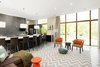 Modern home with Living Room, Chair, Sofa, End Tables, Ottomans, Coffee Tables, Recessed Lighting, Ceiling Lighting, Concrete Floor, and Floor Lighting. Living and dining area Photo 2 of The Milton House