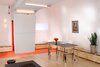 Modern home with Living Room, Coffee Tables, Ceiling Lighting, Plywood Floor, Wall Lighting, Bench, Carpet Floor, Table, Stools, Storage, and Desk. Main multi-mode room looking toward front entry with folding entry wall and custom multi-mode table Photo 2 of Facade/Fasad
