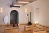 Modern home with Living Room, Bench, Lamps, Ceiling Lighting, Storage, Wall Lighting, and Plywood Floor. Rear end of main multi-mode room set for performance with custom mobile storage benches Photo 13 of Facade/Fasad