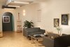 Modern home with Living Room, Bench, Sofa, Storage, Ceiling Lighting, Coffee Tables, Wall Lighting, and Plywood Floor. Rear end of main multi-mode room set for living with custom multi-mode table Photo 14 of Facade/Fasad