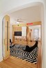 Modern home with Kids Room, Playroom Room Type, Bookcase, Chair, Bedroom Room Type, Shelves, Storage, Medium Hardwood Floor, Rug Floor, Pre-Teen Age, Boy Gender, and Neutral Gender. Playroom open to bedroom with storage units Photo 2 of LO Residence Playroom/Bedroom