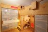 Modern home with Bedroom, Bed, Bookcase, Shelves, Recessed Lighting, Storage, Accent Lighting, and Medium Hardwood Floor. Bedroom with stair to sleeping loft with step-storage and bedroom moving divider panel (closed) Photo 8 of LO Residence Playroom/Bedroom