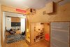 Modern home with Bedroom, Bed, Storage, Shelves, Recessed Lighting, Bookcase, Accent Lighting, and Medium Hardwood Floor. Bedroom with stair to sleeping loft with step-storage and playroom beyond with moving storage unit Photo 9 of LO Residence Playroom/Bedroom