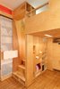 Modern home with Bedroom, Bed, Bunks, Storage, Recessed Lighting, Shelves, Accent Lighting, and Medium Hardwood Floor. Close-up stair to sleeping loft with step-storage Photo 10 of LO Residence Playroom/Bedroom