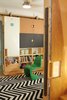 Modern home with Kids Room, Bookcase, Playroom Room Type, Storage, Shelves, Medium Hardwood Floor, Pre-Teen Age, Boy Gender, and Neutral Gender. Moving storage unit in playroom with usable surfaces on doors and work table (up) Photo 12 of LO Residence Playroom/Bedroom