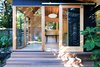 Modern home with Boulders, Wood Patio, Porch, Deck, Hanging Lighting, Landscape Lighting, Horizontal Fences, Wall, and Kids Room. The Shudio exterior and interior. Photo 4 of The Shudio