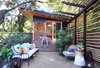 Modern home with Woodland, Garden, Slope, Back Yard, Trees, Shrubs, Flowers, Grass, Hardscapes, Boulders, Walkways, Gardens, Small Patio, Porch, Deck, Decomposed Granite Patio, Porch, Deck, Decking Patio, Porch, Deck, Pavers Patio, Porch, Deck, Hanging Lighting, Stone Patio, Porch, Deck, Landscape Lighting, and Horizontal Fences, Wall. The Shudio and Patio with Seth Photo 7 of The Shudio