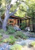 Modern home with Outdoor, Back Yard, Garden, Woodland, Trees, Flowers, Shrubs, Boulders, Small Patio, Porch, Deck, Walkways, Decomposed Granite Patio, Porch, Deck, Pavers Patio, Porch, Deck, Gardens, Landscape Lighting, Decking Patio, Porch, Deck, Horizontal Fences, Wall, and Hanging Lighting. The Shudio and patio with dry river bed in foreground Photo 8 of The Shudio