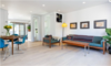 Modern home with Living Room, Chair, Sofa, Table, Coffee Tables, Storage, Shelves, Lamps, Ceiling Lighting, Floor Lighting, Recessed Lighting, and Light Hardwood Floor. Living Room Photo 3 of East Pender home
