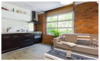 Modern home with Living Room, Sofa, Coffee Tables, Ceiling Lighting, Storage, Light Hardwood Floor, Pendant Lighting, and Accent Lighting. Lower Suite Living Room/Kitchen Photo 10 of East Pender home