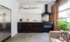 Modern home with Kitchen, White Cabinet, Concrete Floor, Metal Backsplashe, Recessed Lighting, Refrigerator, Cooktops, Ceiling Lighting, Range Hood, Range, Drop In Sink, and Undermount Sink. Lower Suite Living Room/Kitchen Photo 11 of East Pender home