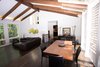 Modern home with Living Room, Ceiling Lighting, Sofa, Dark Hardwood Floor, and Sectional. Great room and dining area Photo of House in the Trees