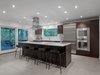 Modern home with Kitchen, Wall Oven, Engineered Quartz Counter, Ceiling Lighting, Wood Cabinet, Refrigerator, Cooktops, Undermount Sink, and Ceramic Tile Floor. Kitchen Photo 3 of House in the Trees