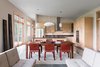 Modern home with Kitchen, Concrete Floor, Wood Cabinet, Pendant Lighting, Refrigerator, Wall Oven, Range Hood, Range, and Undermount Sink. The main living spaces are arranged in a light-filled open floor plan. Photo 2 of Craven Gap Residence