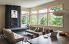 Modern home with Living Room, Pendant Lighting, Recessed Lighting, Gas Burning Fireplace, Standard Layout Fireplace, Sofa, and Concrete Floor. The dark, oxidized steel fireplace anchors the living room. Photo 3 of Craven Gap Residence