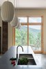 Modern home with Kitchen, Pendant Lighting, Concrete Floor, and Undermount Sink. Sliding door to the balcony is located off the kitchen space. Photo 4 of Craven Gap Residence