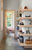 Modern home with Hallway and Concrete Floor. Cantilevered maple shelving at the central stair shows off an eclectic art collection. Photo 5 of Craven Gap Residence