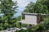 Modern home with Exterior, House Building Type, Metal Roof Material, and Concrete Siding Material. The home looks out over a valley in Western North Carolina. Photo 7 of Craven Gap Residence