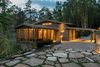Modern home with Exterior, House Building Type, Metal Roof Material, Wood Siding Material, and Gable RoofLine. The understated exterior and the thoughtfully chosen palette blend the home into the topography. Photo of Fontana Lake House
