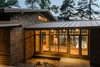 Modern home with Exterior, House Building Type, Metal Roof Material, Wood Siding Material, and Gable RoofLine. The entry is a contemporary glass-enclosed interpretation of a “dogtrot” – a traditional breezeway connecting two enclosed spaces. Photo 2 of Fontana Lake House