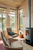 Modern home with Living Room, Gas Burning Fireplace, Light Hardwood Floor, Wall Lighting, and Chair. The simple, clean-lined fireplace at the corner of the living room. Photo 5 of Fontana Lake House