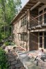 Modern home with Outdoor, Stone Patio, Porch, Deck, Trees, Boulders, Hardscapes, Back Yard, Shrubs, and Grass. Terrace at the back of the home that faces the lake. Photo 8 of Fontana Lake House