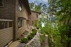 Modern home with Exterior, House Building Type, Metal Roof Material, Wood Siding Material, and Gable RoofLine. Terrace at the back of the home that faces the lake. Photo 9 of Fontana Lake House