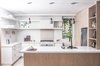 Modern home with Kitchen, Refrigerator, Range, Pendant Lighting, Recessed Lighting, Open Cabinet, Wall Oven, Undermount Sink, and Light Hardwood Floor. <span style="font-family: Theinhardt, -apple-system, BlinkMacSystemFont, "Segoe UI", Roboto, Oxygen-Sans, Ubuntu, Cantarell, "Helvetica Neue", sans-serif;">For this small west Toronto renovation, rather than imagine a home comprised of rooms within an open plan the architects conceived a room revolving around a singular mass.</span> Photo 5 of Sheridan Residence