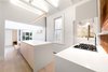 Modern home with Kitchen, Engineered Quartz Counter, Wood Cabinet, Light Hardwood Floor, Ceiling Lighting, Brick Backsplashe, Pendant Lighting, Recessed Lighting, Accent Lighting, Cooktops, Range, and Range Hood. Kitchen Photo 3 of Curtain Cottage