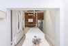 Modern home with Kitchen, Engineered Quartz Counter, Wood Cabinet, Brick Backsplashe, Pendant Lighting, and Light Hardwood Floor. Kitchen (Day) Photo 16 of Curtain Cottage
