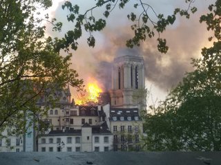 One of the cathedral's two towers can be seen here as the roof is engulfed in flames. 