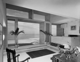 Large windows throughout the home frame views of the Atlantic Ocean.