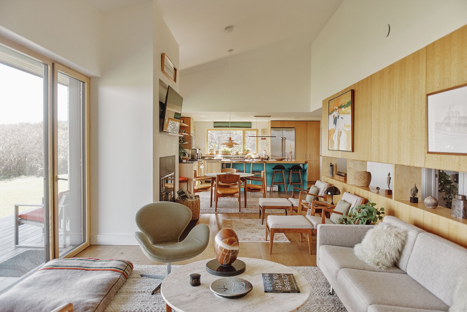 A view of the open plan living space inspired by Jens RIsoms Danish childhood. Risom Library chairs from the early 1960s surround the dining table.