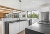Modern home with Kitchen, Engineered Quartz Counter, Wood Cabinet, White Cabinet, Cork Floor, Ceiling Lighting, Recessed Lighting, Pendant Lighting, Accent Lighting, Cooktops, Drop In Sink, and Refrigerator. The custom kitchen features quartz countertops. Photo 8 of Copperwood