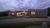 Modern home with Outdoor, Front Yard, Trees, Grass, Shrubs, Hardscapes, Decking Patio, Porch, Deck, Landscape Lighting, and Large Patio, Porch, Deck. Evening at Copperwood. The 20-acre lot enjoys visits from deer, eagles, hawk, blue heron, fox, and other wildlife. Photo 11 of Copperwood