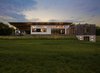 Modern home with Outdoor, Back Yard, Slope, Field, Hardscapes, Decking Patio, Porch, Deck, Large Patio, Porch, Deck, Trees, Grass, and Landscape Lighting. The slanted metal roof extends out over the Airstream, where it sits connected to power, sewer, and water. Photo 10 of Copperwood