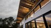 Modern home with Outdoor, Rooftop, Trees, Back Yard, Large Patio, Porch, Deck, Concrete Patio, Porch, Deck, Wood Patio, Porch, Deck, Landscape Lighting, and Metal Patio, Porch, Deck. Roof, Window, Cement Siding Detail Photo 2 of Copperwood