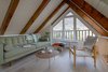 Modern home with Living Room, Chair, Ottomans, Coffee Tables, Sofa, and Medium Hardwood Floor. Upper living room with a beautiful view Photo 8 of From intimicy to social: a weekend apartment in the mountains