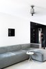 Modern home with Sectional, Sofa, Living Room, and Console Tables. Qlocktwo by Biegert & Funk makes you stop and look at time in a new dimension. The black surface of the clock in a perfect square contrasting with a clean white wall frames a perfect backdrop for the living room. The ceiling fans are minimalist expressions resembling simple geometric extrusions of form. The Pensi fan by The Modern Fan Company is named after its renowned Spanish designer Jorge Pensi. Photo 2 of Living in Monochrome, far away from Nordic lands